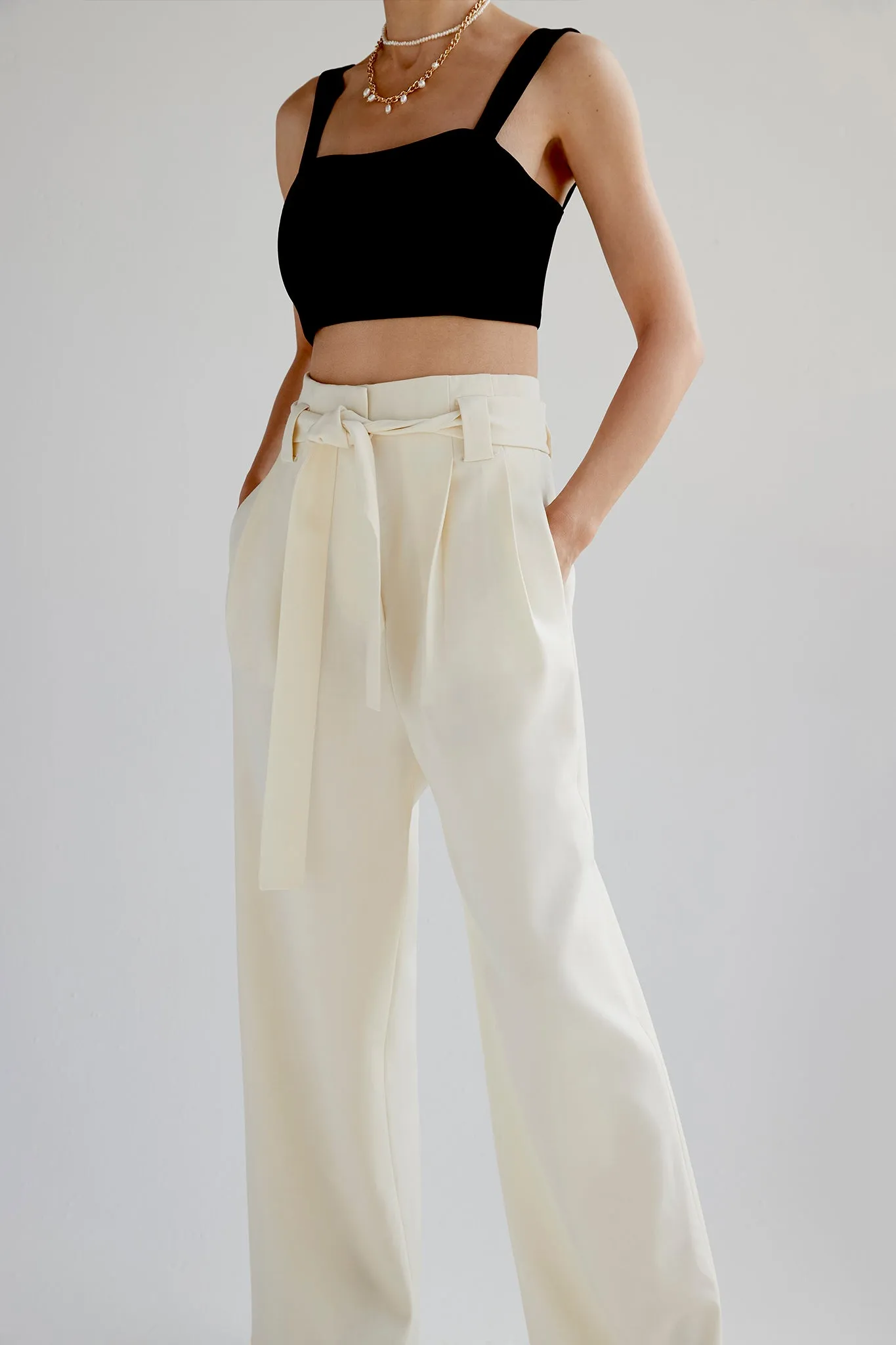 Belted cotton wide leg pleated pants in cream